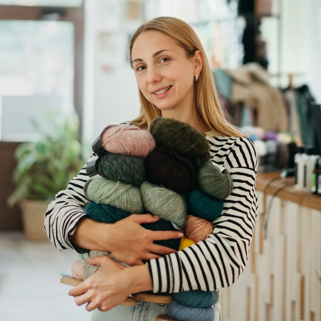 Person holding Darn Good Yarn wool