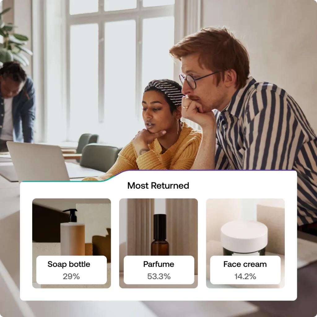 2 employees reading return data with ReturnLogic's software showing most returned items. 