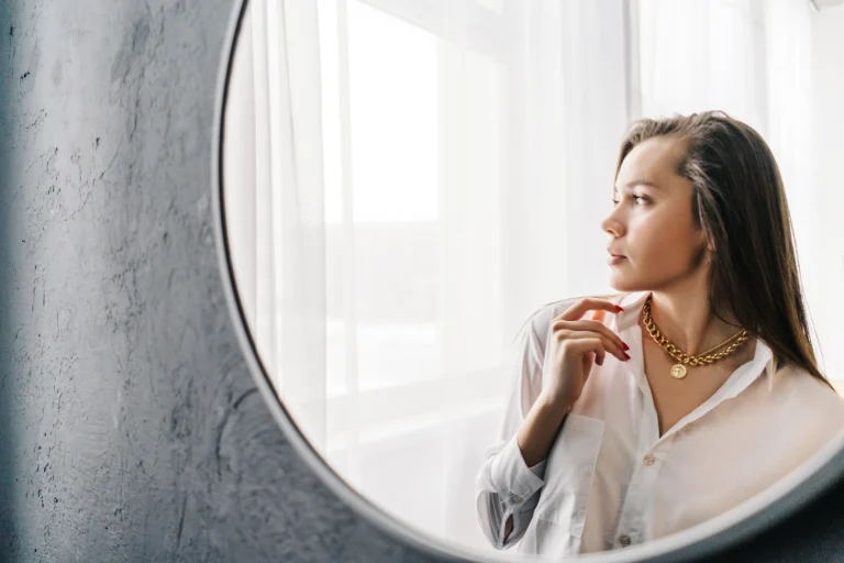 Woman wearing neck pedant looking out